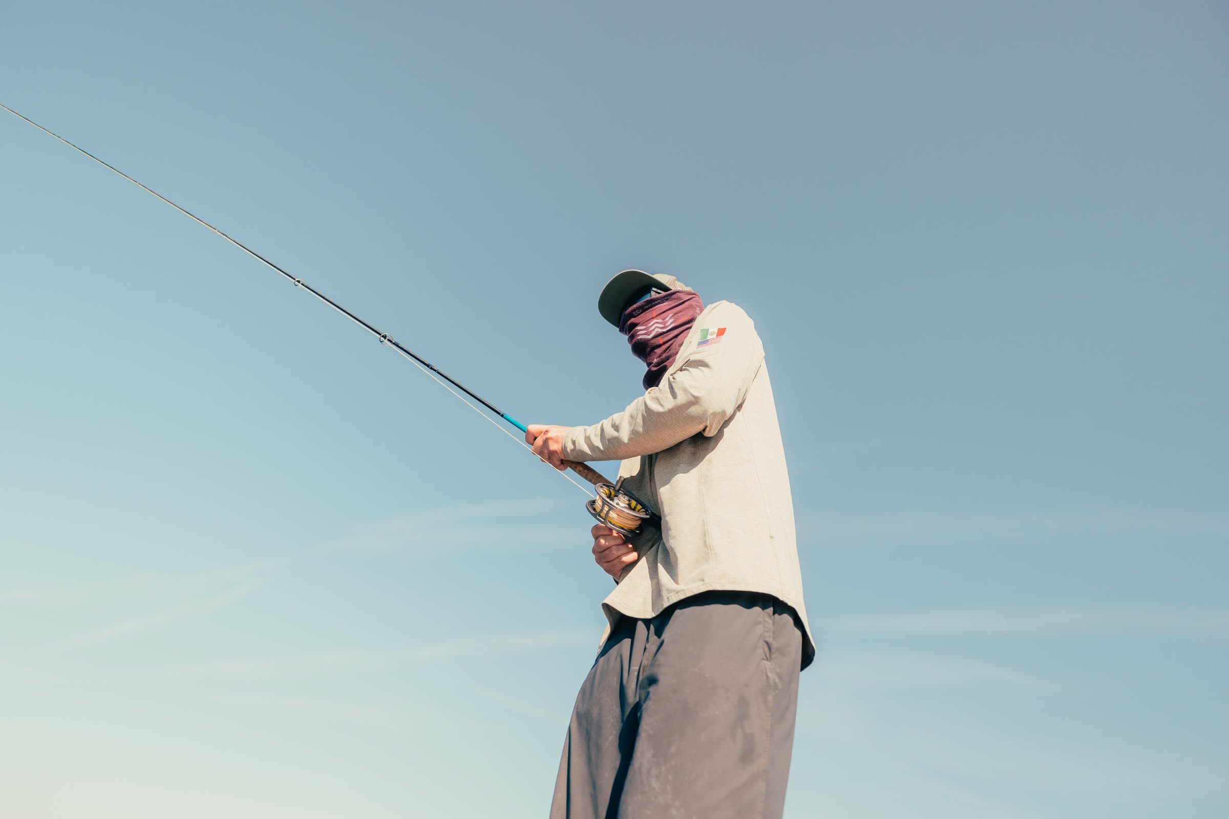Angler hooked up on a saltwater fly rod while targeting Louisiana redfish.